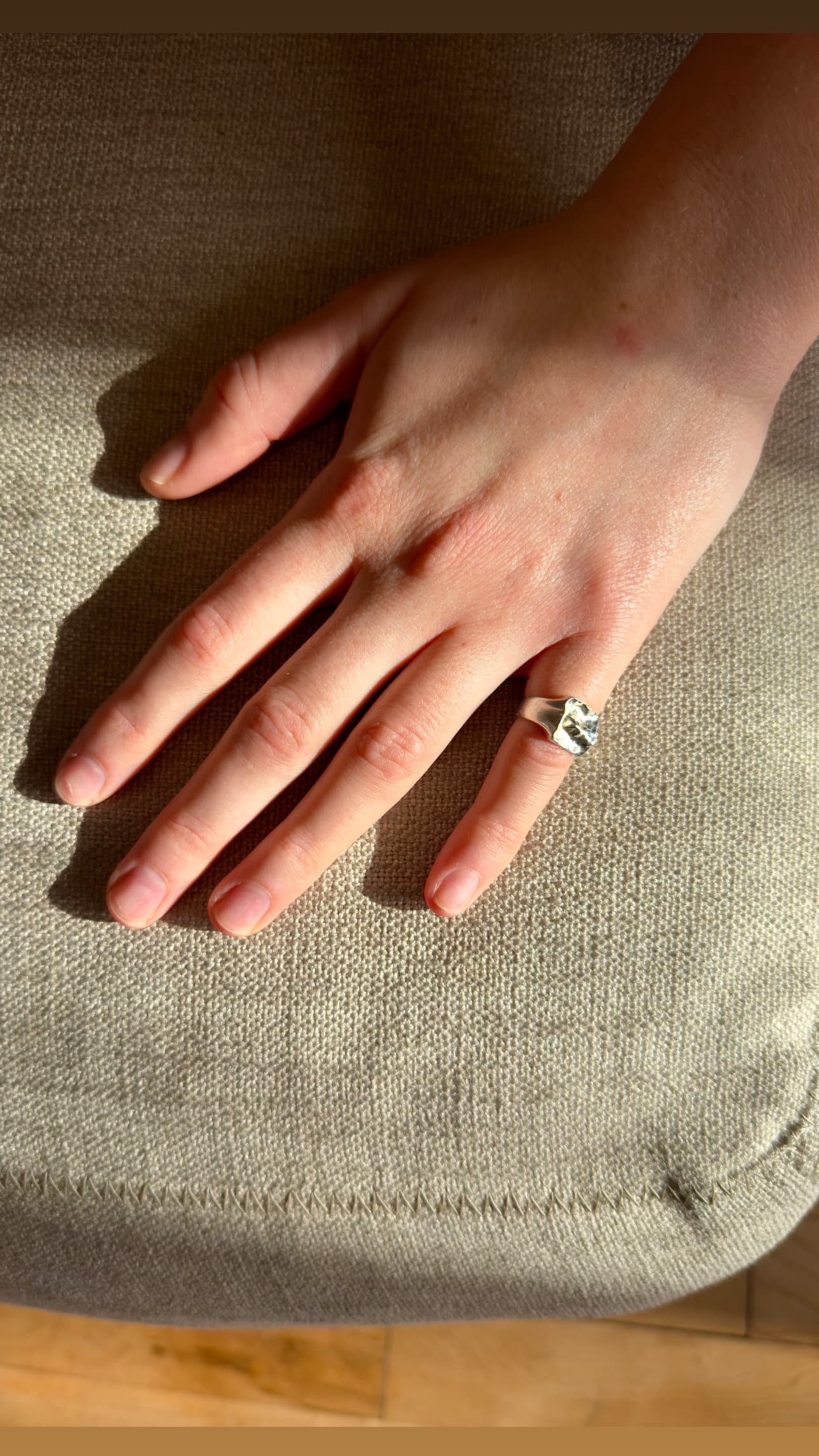 Custom map ring photographed in natural light on neutral background