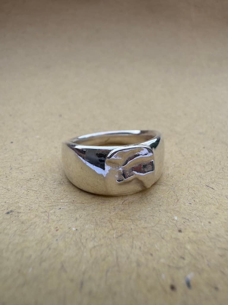 Custom map jewellery ring highlighting a coastline landscape