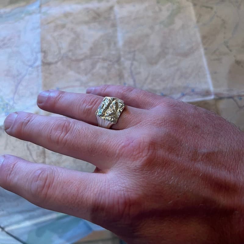 Customer wearing a WILDRING custom map ring inspired by wild mountain terrain